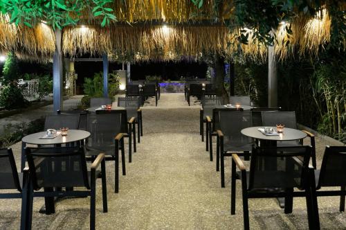a row of tables and chairs in a restaurant at Atrium Hotel Thassos in Potos