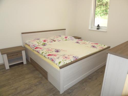 a bedroom with a bed with a flowery mattress at Apartmány Starovice in Starovice