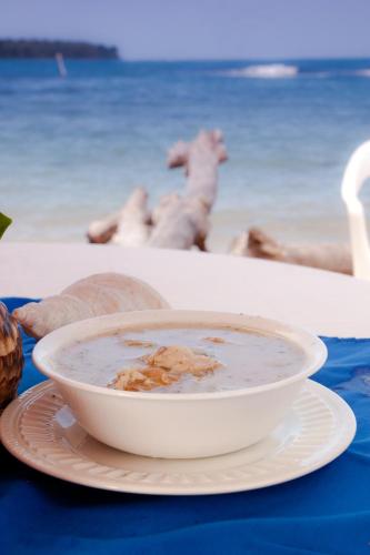 a bowl of soup on a plate on a table at Hospedaje Yarisnori in Bocas del Toro
