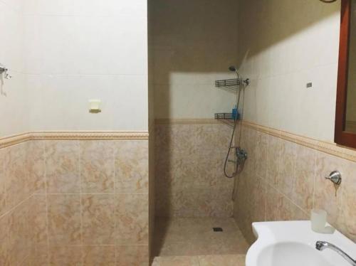 a bathroom with a shower and a toilet and a sink at Apartament Balakhvani in Kutaisi