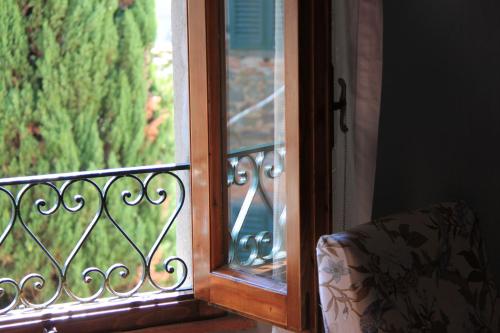 a glass door with a view of a garden at antica casa "le rondini" in Borgo a Buggiano