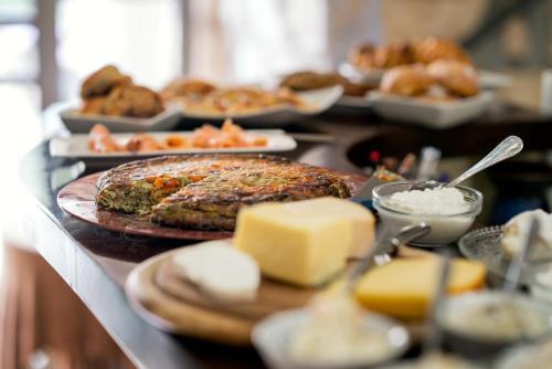 a buffet of food with meat and cheese and pastries at Artists' Colony Inn Zefat in Safed