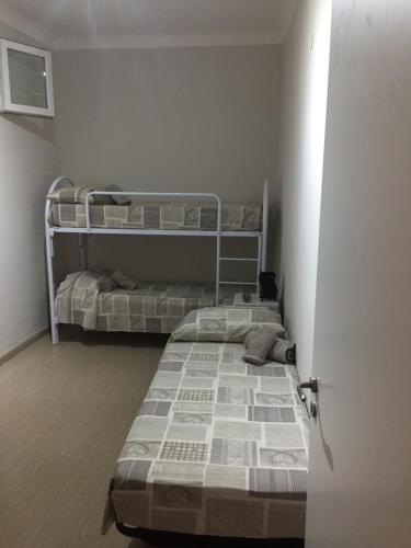 two bunk beds in a small room with a door at Berenice in Taranto