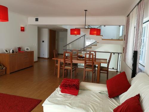 a living room with a couch and a table with chairs at Alentejo`s Nest in Alcácer do Sal