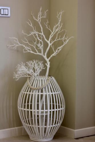 a white vase with a plant in it at Townhouse Tropea in Tropea