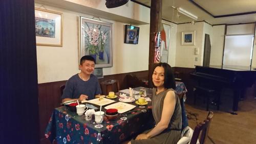 a man and woman sitting at a table in a restaurant at Live Cafe Hisui no Umi in Itoigawa