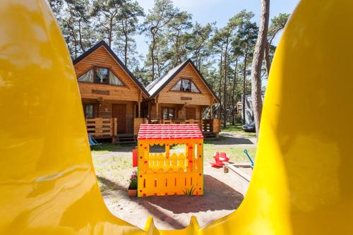 a red and yellow fire hydrant sitting in front of a building at Sosnowa Mila in Pobierowo