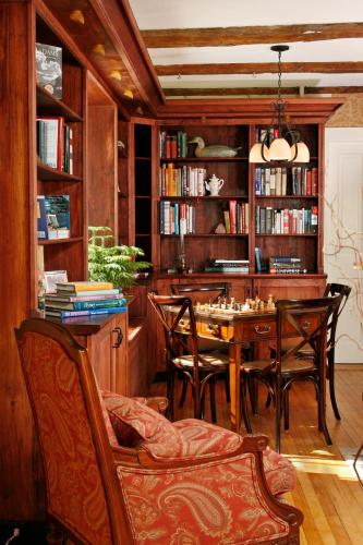 a dining room with a table and chairs and bookshelves at Sugar Hill Inn in Sugar Hill