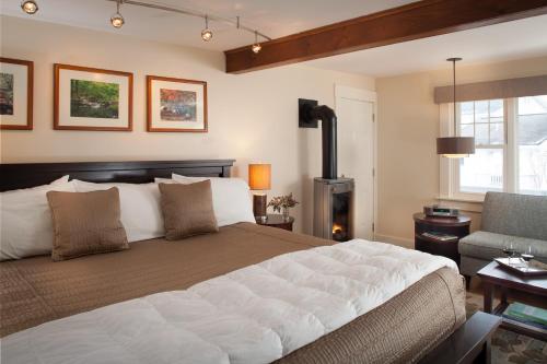 a bedroom with a large bed and a fireplace at Sugar Hill Inn in Sugar Hill