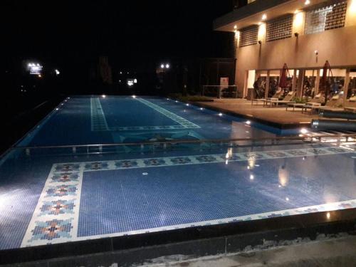 a large swimming pool at night at Sayaji Kolhapur in Kolhapur