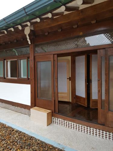 a building with glass doors on the side of it at The Hanok in Jeonju