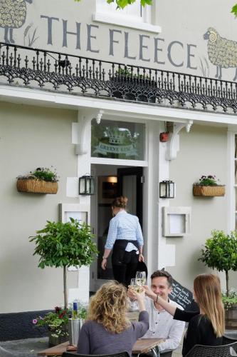 a group of people sitting at a table drinking wine at The Fleece in Witney
