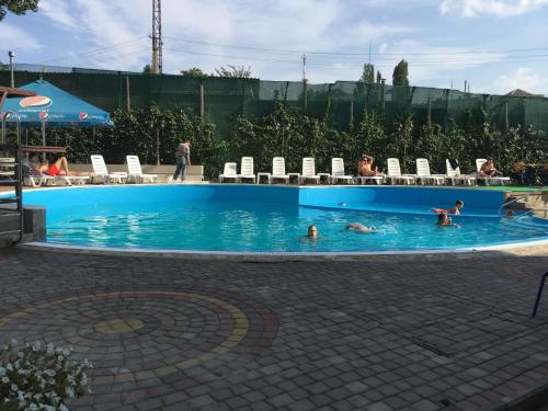 a group of people swimming in a swimming pool at Karavella in Mykolaiv