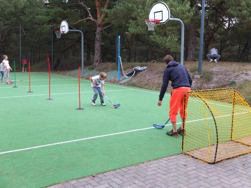 a man and a boy playing a game of basketball at Best Western Hotel Jurata in Jurata