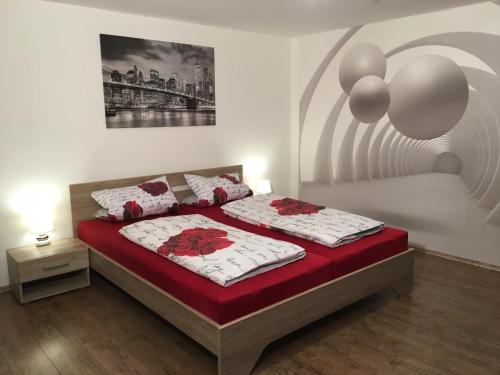 a bedroom with a bed with red and white sheets at Apartment Royal Bavaria in Füssen