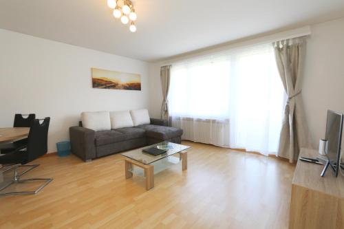 a living room with a couch and a table at Apartment Bünda in Davos