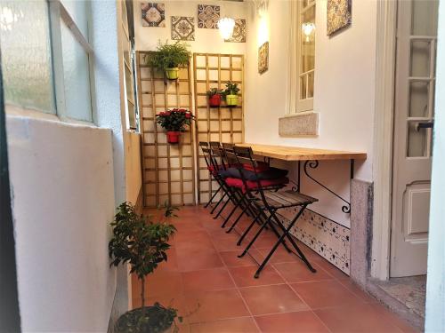 a small room with a table and chairs on a patio at Estrela Charming Rooms by HOST-POINT in Lisbon