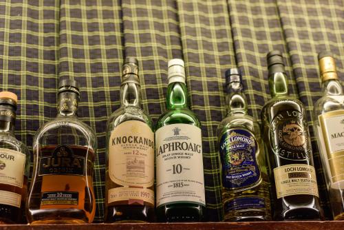 a bunch of bottles of alcohol on a table at Edenhall Country Hotel in Penrith