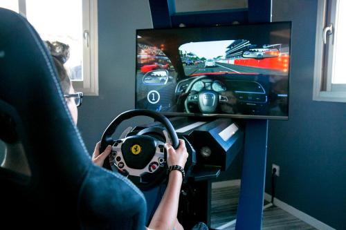 a person playing a video game on a tv at Grand Palladium Select Palace Ibiza - All Inclusive in Playa d'en Bossa