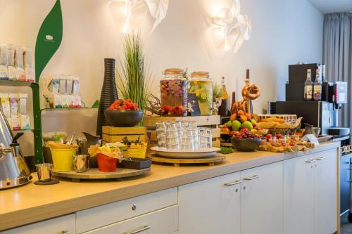 a buffet with fruit and drinks on a table at Park Inn by Radisson Nürnberg in Nuremberg