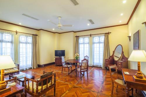 a living room with a table and chairs at Mount Lavinia Hotel in Mount Lavinia