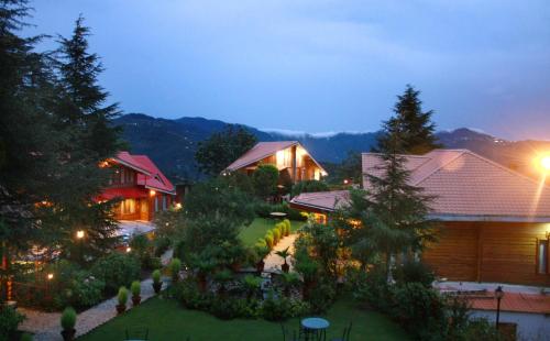 an aerial view of a house with a garden at night at The Chalets Naldehra in Shimla