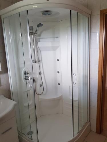 a shower with a glass enclosure in a bathroom at Apartment Lavanda in Starigrad