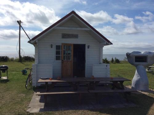 a small house with a picnic table in front of it at Seaside cottage in Kõiguste