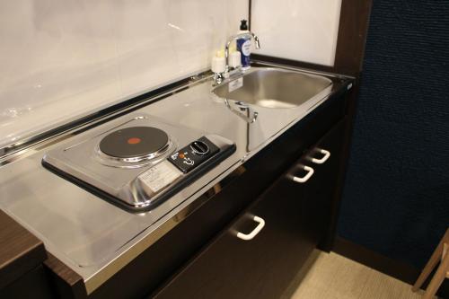 a sink in a small room with a sink at Hakodate Classic Hotels in Hakodate