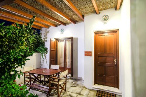 a room with a table and a wooden door at Anemonisia Skyrian Living in Skiros