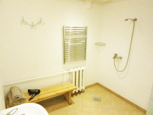 a bathroom with a shower and a bench in it at Villa Lille in Pärnu