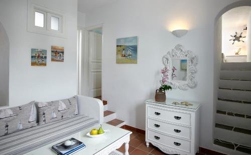 a white room with a white dresser and a mirror at Folegandros Apartments in Chora Folegandros