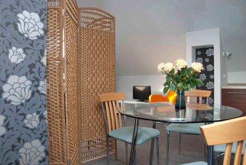 a dining room with a table and chairs at Prima in Puławy