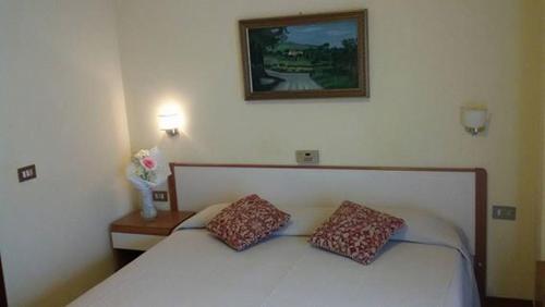 Säng eller sängar i ett rum på Hotel Le Vigne
