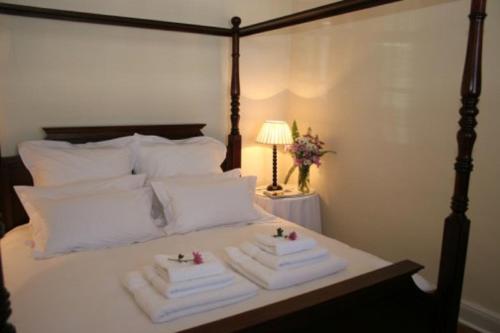 a bedroom with a bed with towels on it at De Kothuize 16 in Graaff-Reinet