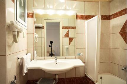 a bathroom with a white sink and a mirror at Palladion Hotel in Ioannina