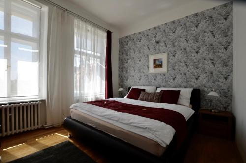 a bedroom with a large bed in front of a window at Beautiful Apartments in Prague in Prague