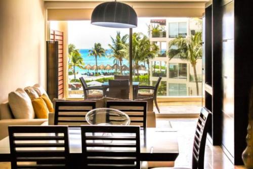 a dining room with a table and chairs at The Elements Oceanfront & Beachside Condo Hotel in Playa del Carmen