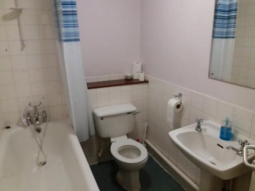 a small bathroom with a toilet and a sink at The Crouch Oak in Addlestone
