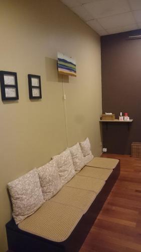 a couch sitting in a room with a wall at 自然海naturalhigh in Dahan