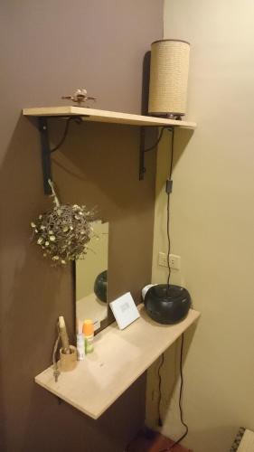 a shelf with a mirror on a wall at 自然海naturalhigh in Dahan