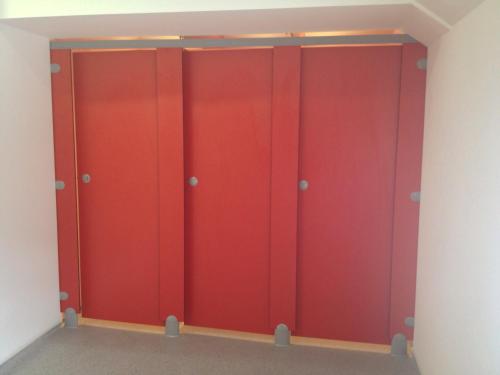 a row of red lockers in a room at Old Mill Holiday Hostel in Westport