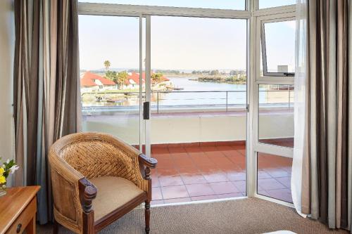 a chair in a room with a large window at First Group Port Owen Marina in Velddrif