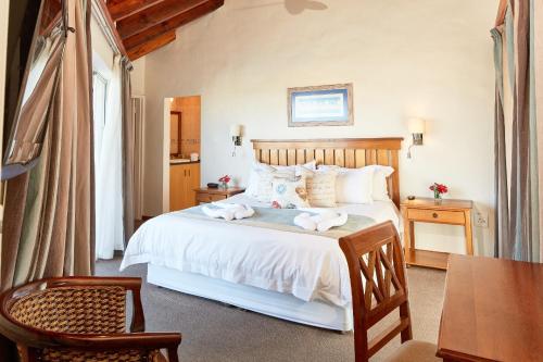 a bedroom with a bed with towels on it at First Group Port Owen Marina in Velddrif