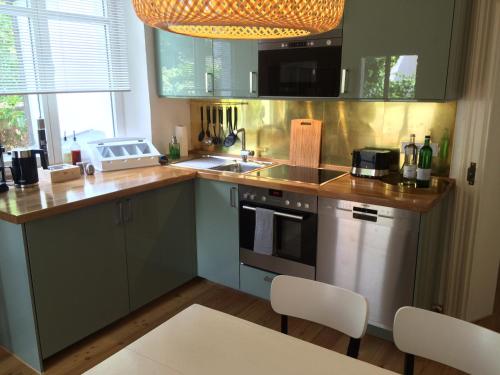 a kitchen with a sink and a stove top oven at Villa Friedrich in Bayreuth