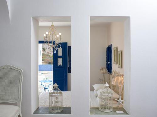 two views of a room with a blue door at Folegandros Apartments in Chora Folegandros