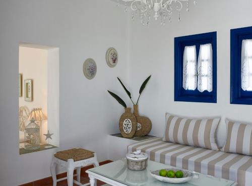a living room with a couch and a table at Folegandros Apartments in Chora Folegandros