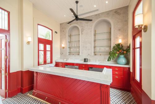 a large kitchen with red cabinets and a red island at American Trade Hotel in Panama City