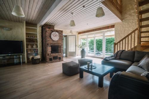 a living room with a couch and a fireplace at Väike-Mere Villa in Haapsalu