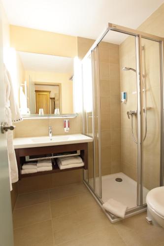 a bathroom with a shower and a sink at Hotel Alter Weißbräu in Bad Birnbach